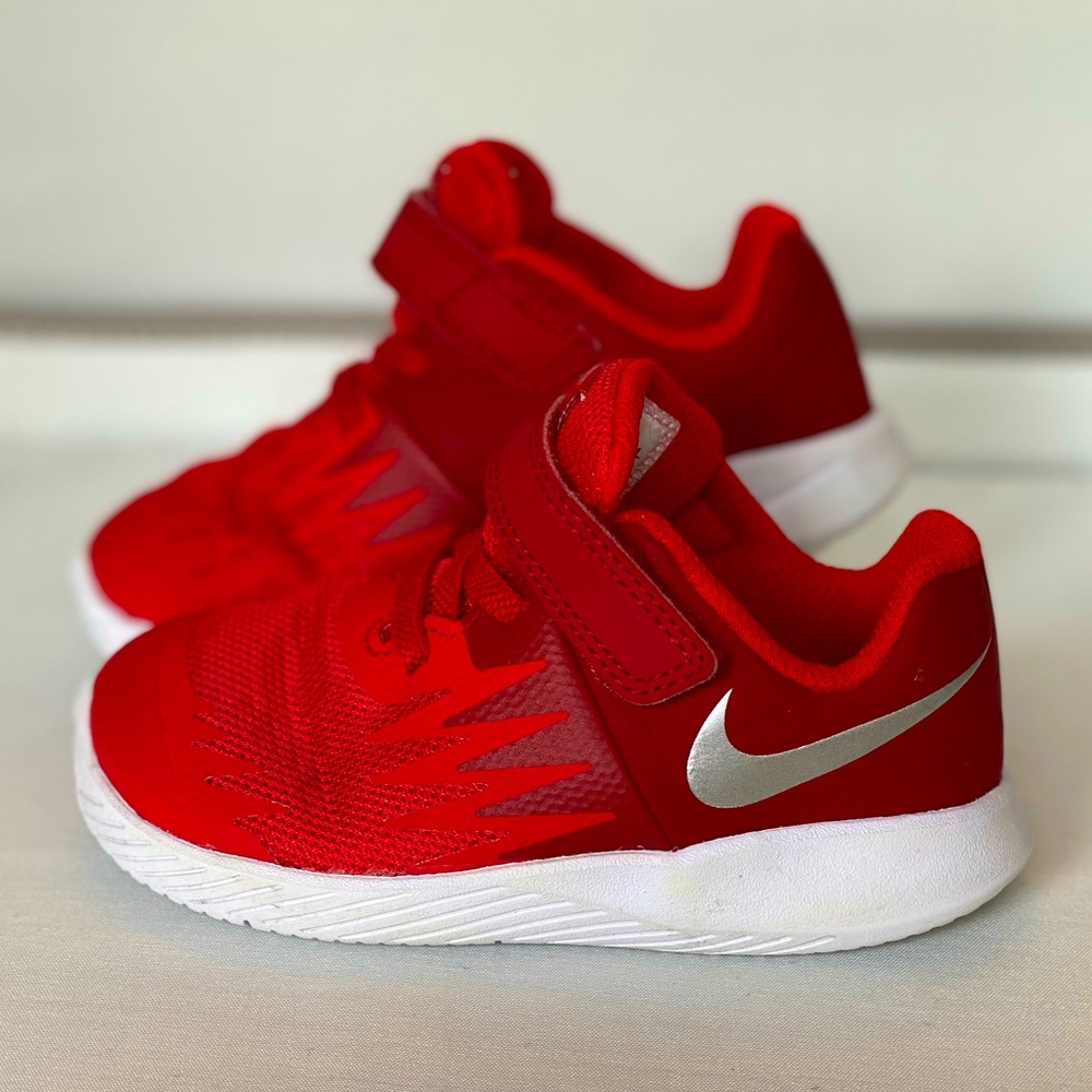 Red Nike sneakers size 7c. Lightly worn.